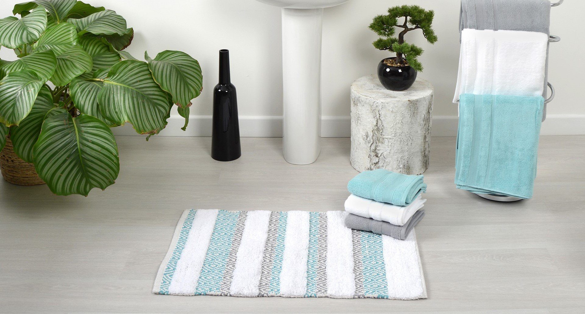 colourful towels and mats in a bright bathroom