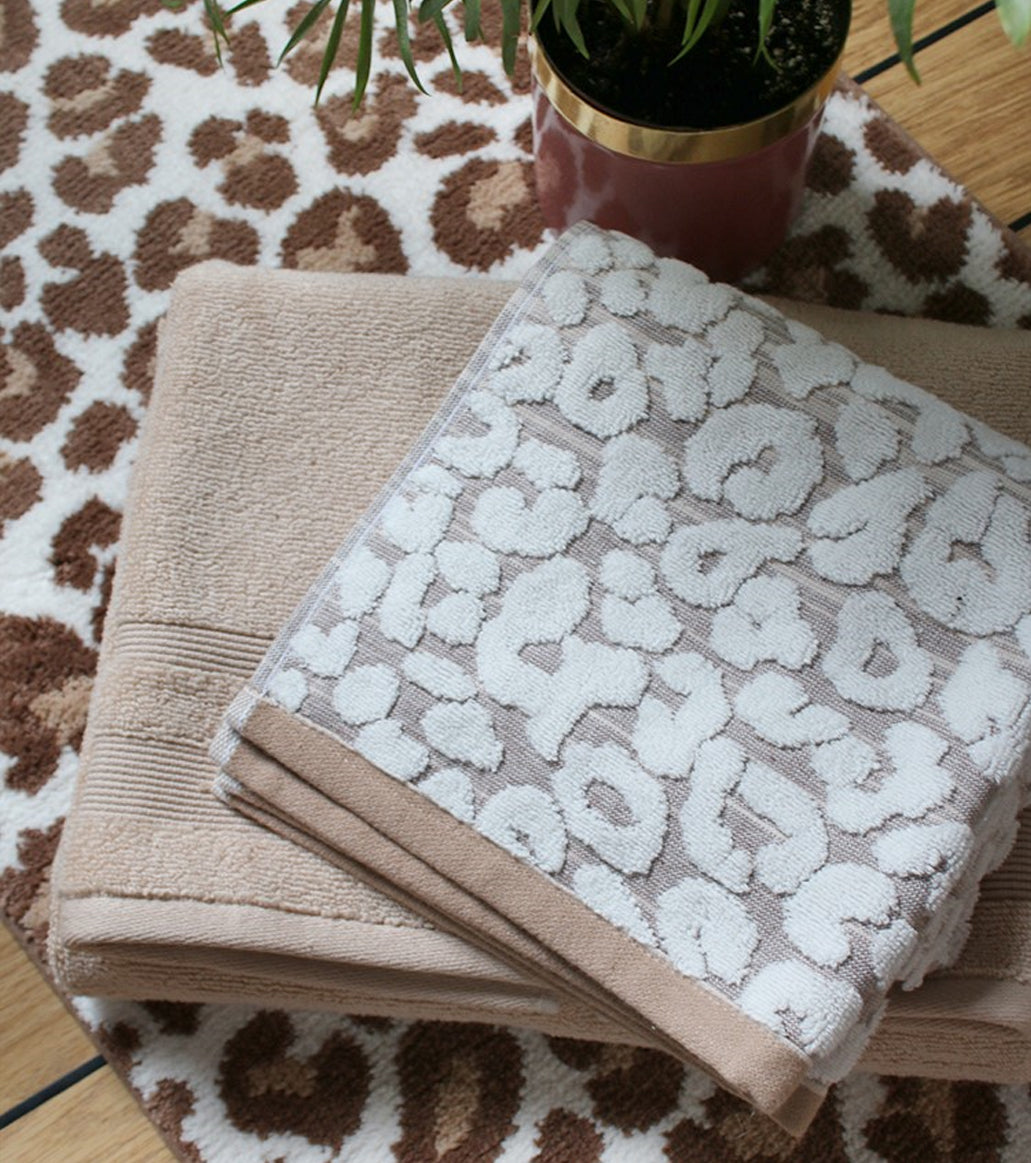Animal print towels and mats in a leopard pattern.