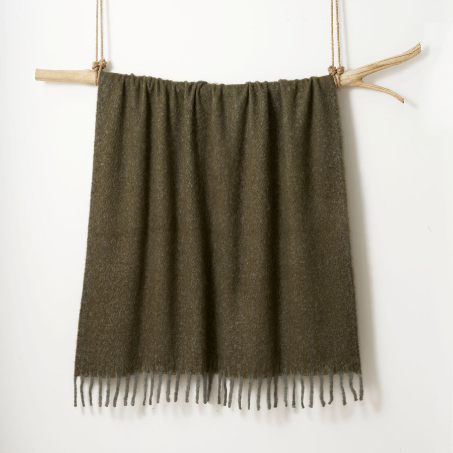 Green throw blanket made from faux mohair.