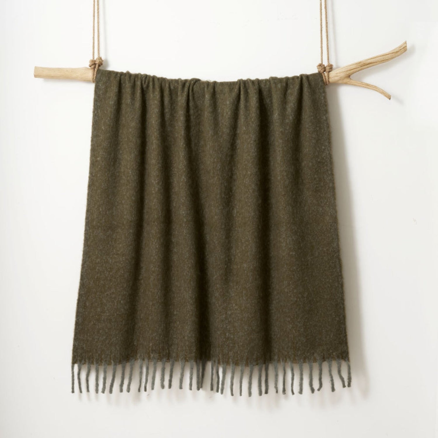 Green throw blanket made from faux mohair.