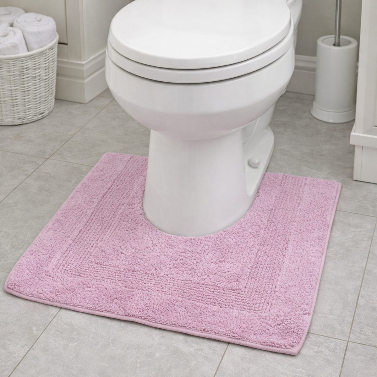Lilac pedestal mat mat in front of a white toilet in a bathroom setting.