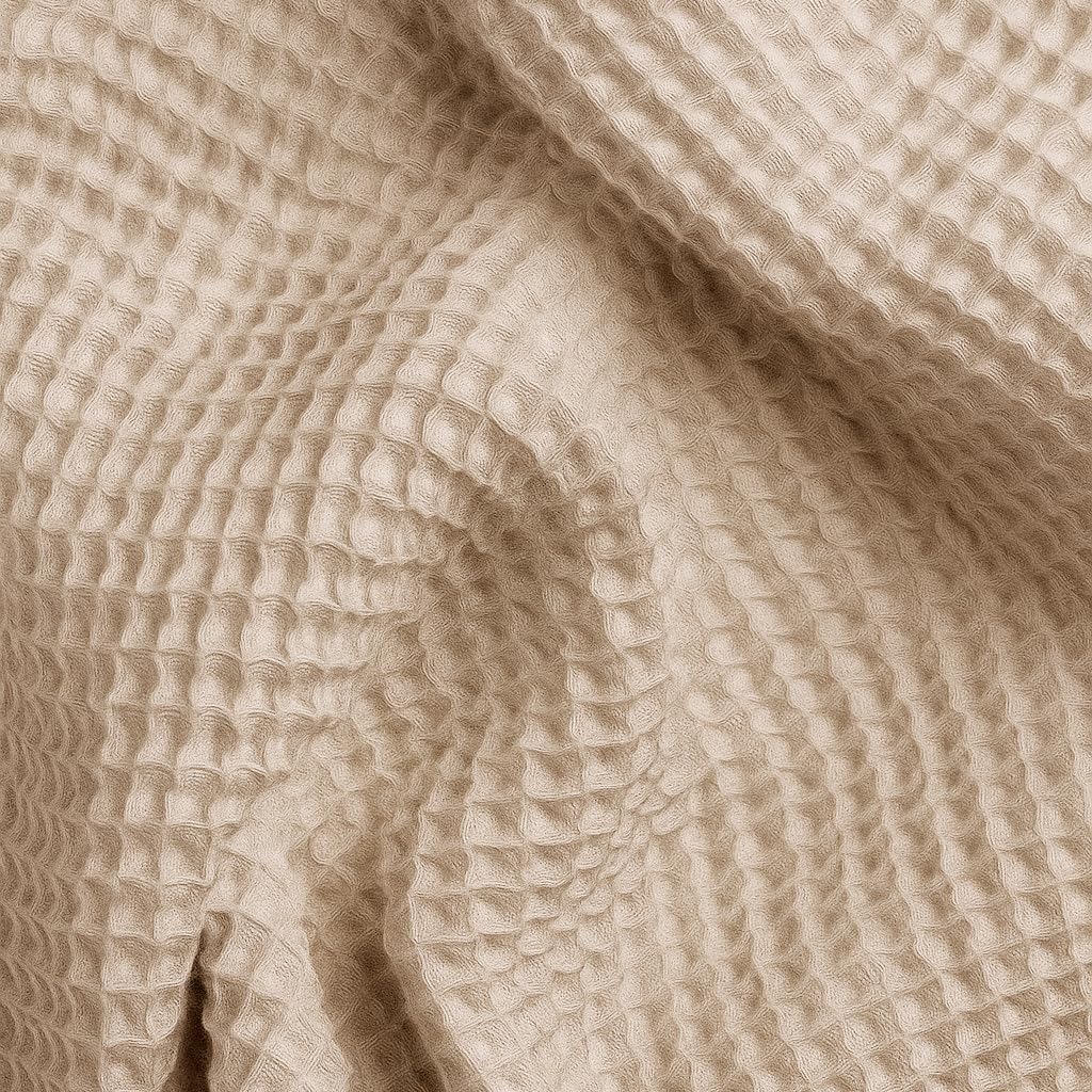 Neutral beige waffle bathrobe close up, textured feel.