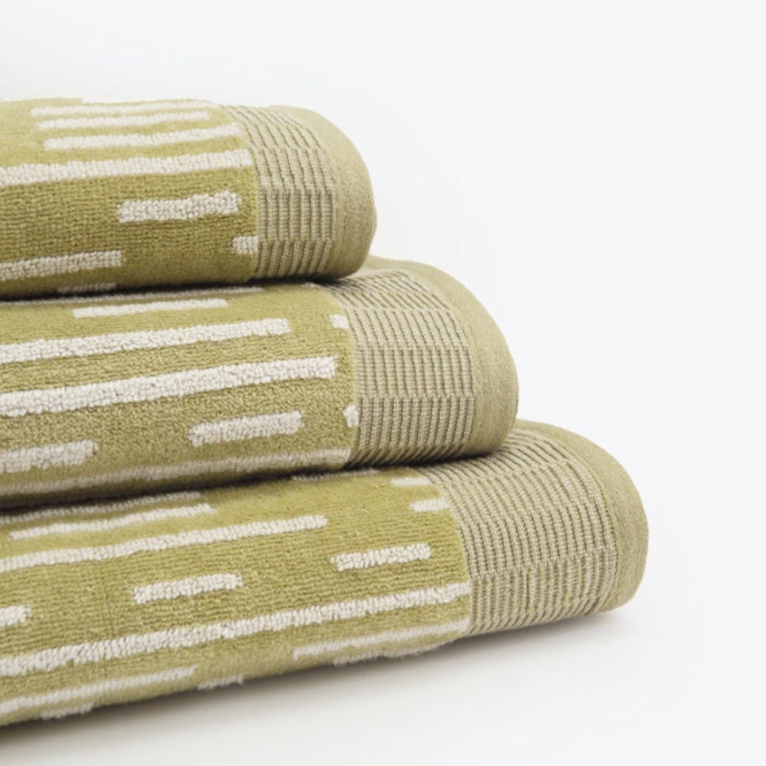 Statement towels for the bathroom in a green and white stripe pattern. Set of three - hand towel, bath towel, and bath sheet.