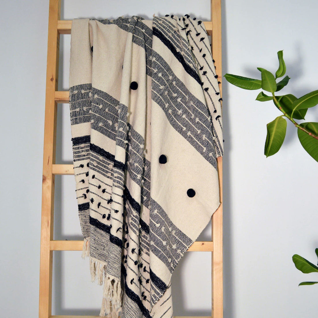 Off white and black boho throw. Textured decorative throw with bobbles and tassels.