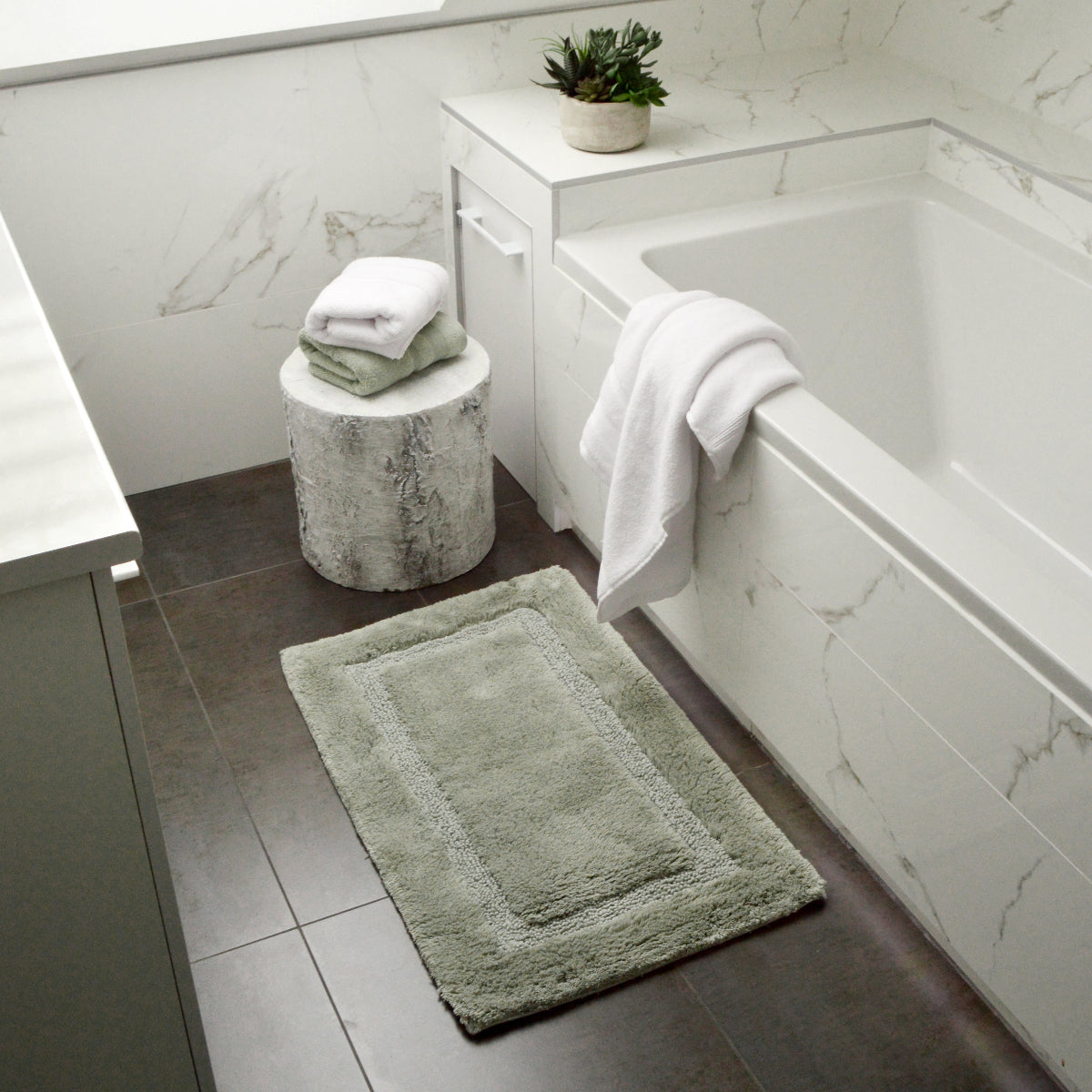 Sage green bathroom mat made from bamboo and cotton.