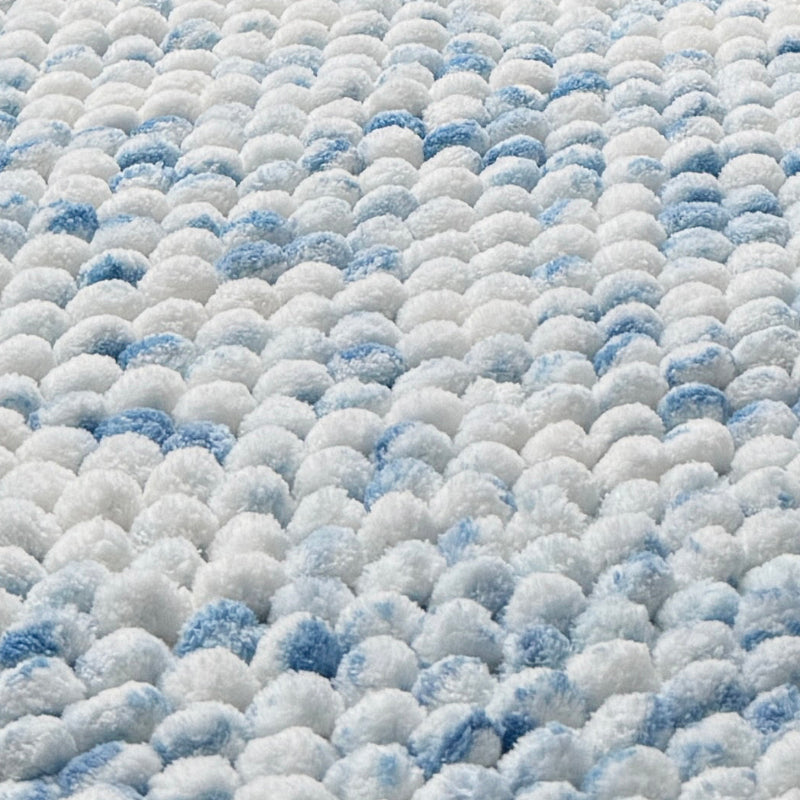 Sky blue bathroom mats in a handwoven chunky bobble pile and marble patterned.