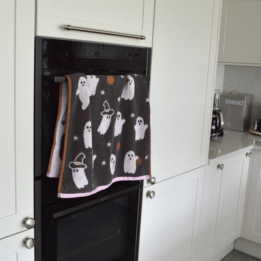 Cute ghost Halloween towels in grey and pink. Kitchen tea towels for fall decor.