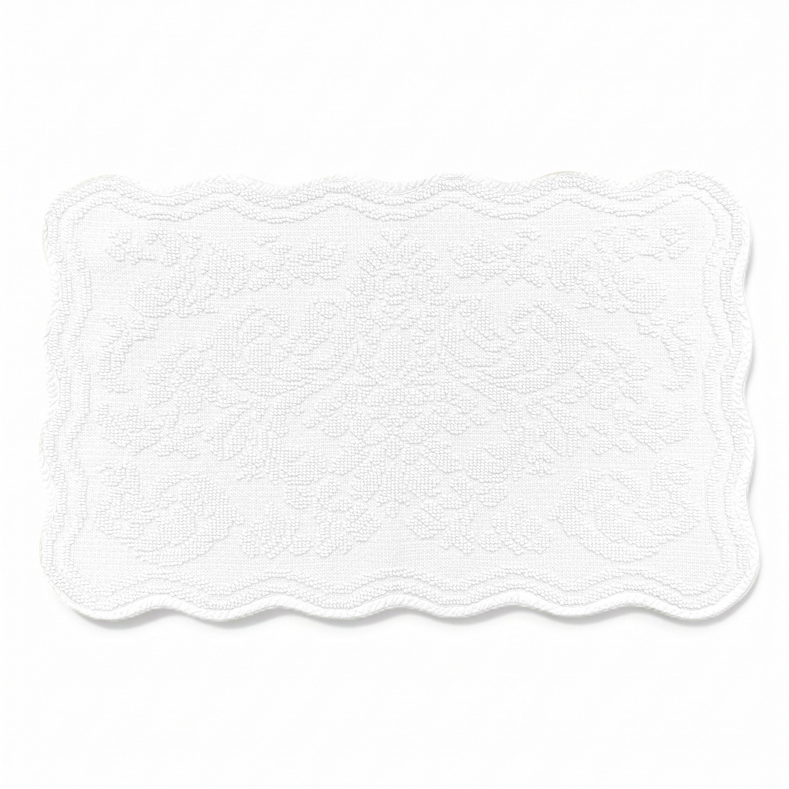 Scalloped bath mat in white colour, with floral texture design - made from 100% cotton.