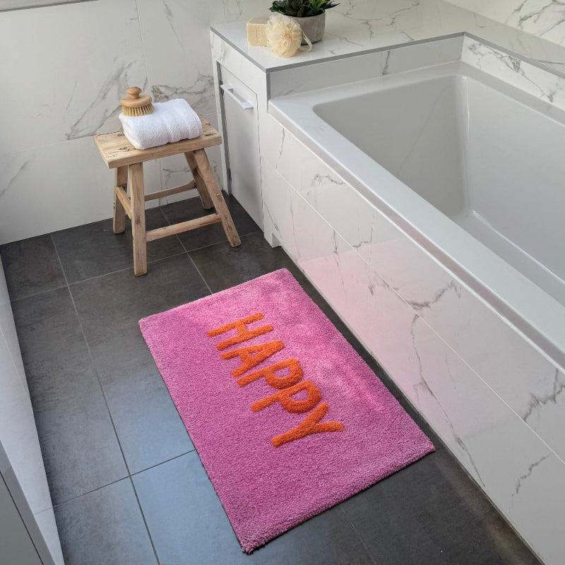 Pink and orange slogan bath mat, fun happy design.
