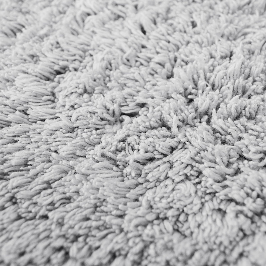 Grey cotton bath mat close up of the combed pile.