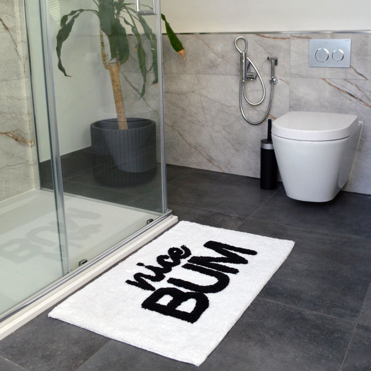 white and black fun bath mat with nice bum slogan.