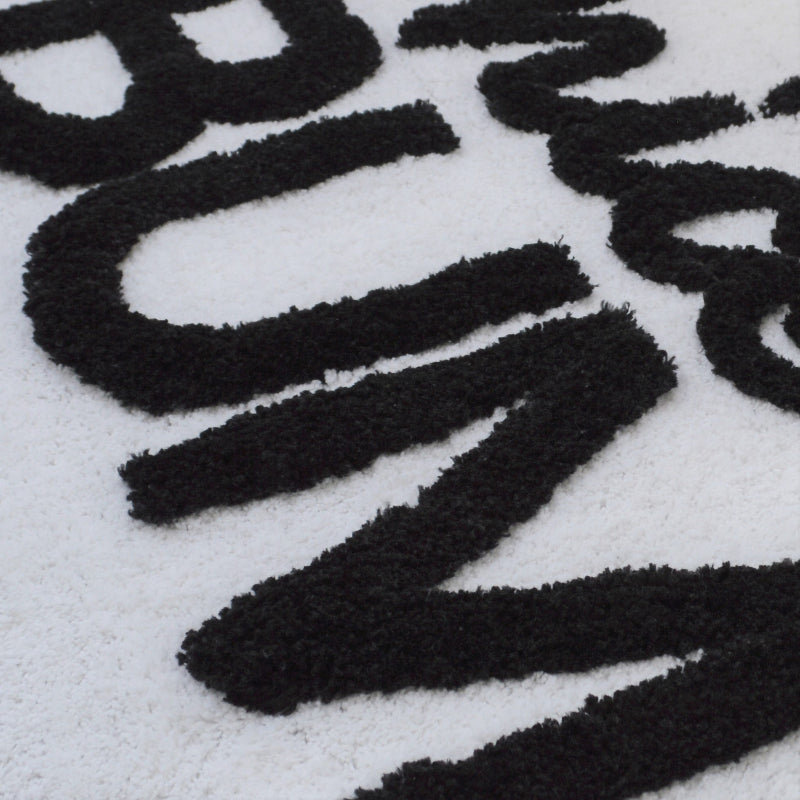 Hand tufted slogan bath mat, fun and playful. White and black rug for the bathroom.