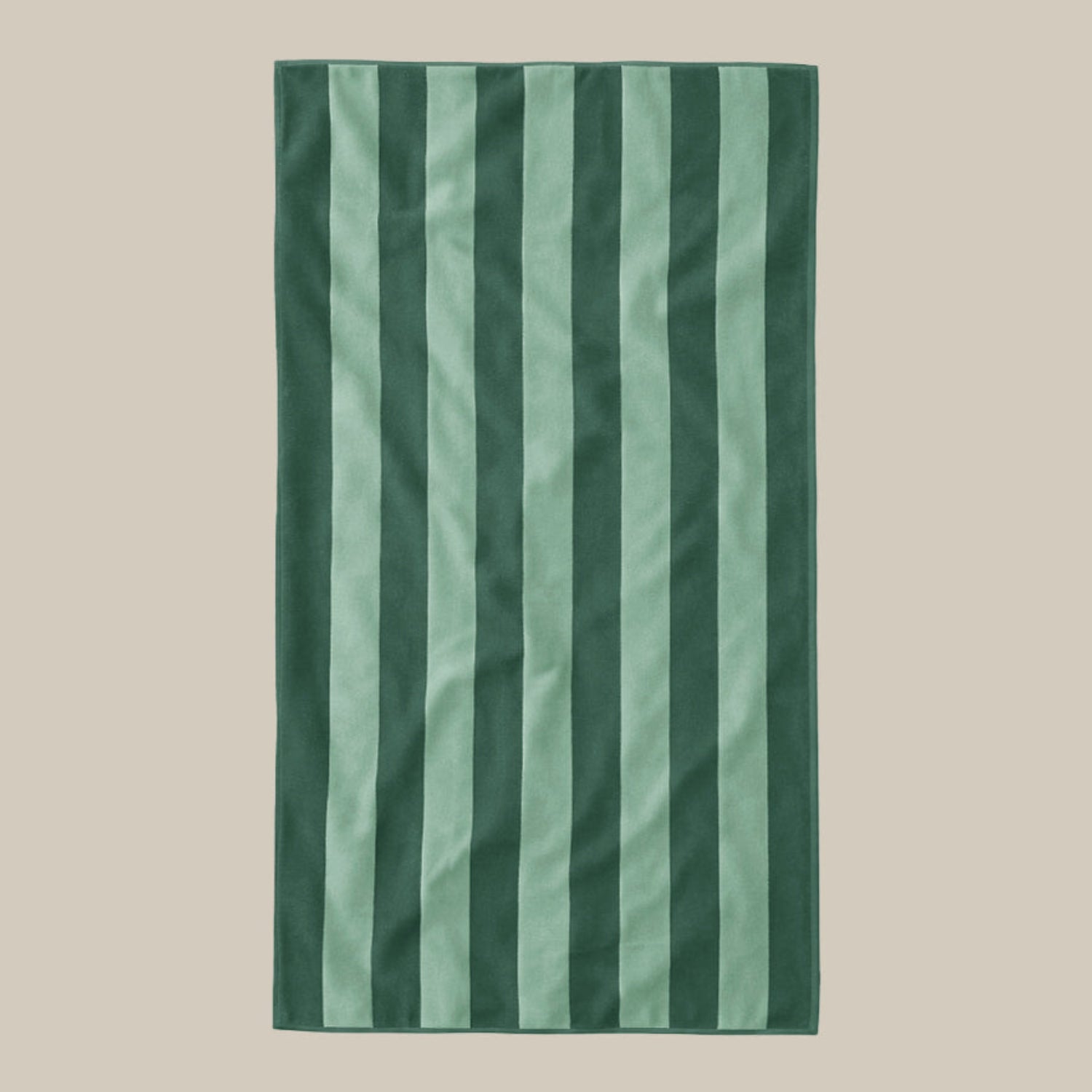 Green striped beach towel on a beige background