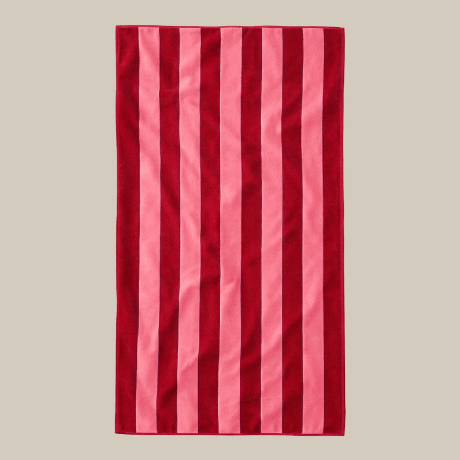 Red and pink striped towel on a beige background