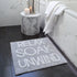 Slogan bath mat, relax soak unwind. Hand tufted bathmat