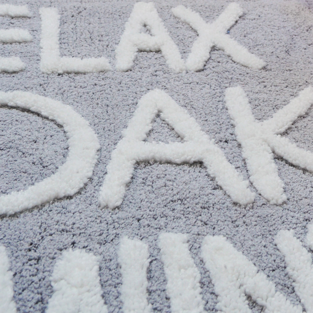 hand tufted slogan bath mat, relax soak unwind