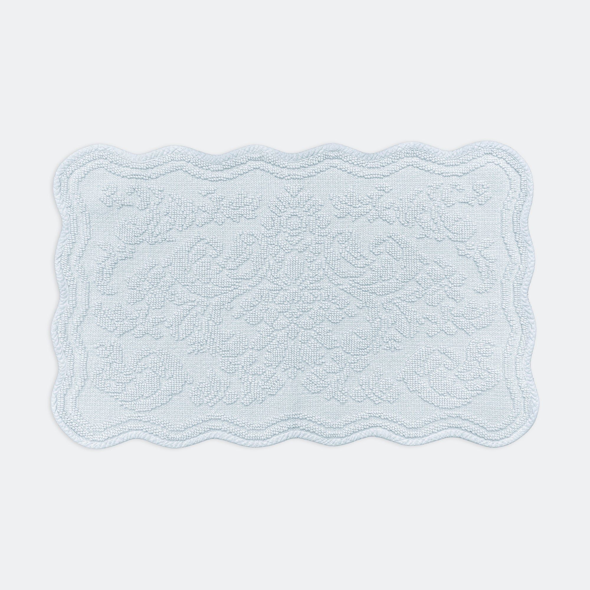 Scalloped bath mat in baby blue colour, with floral texture design - made from 100% cotton.