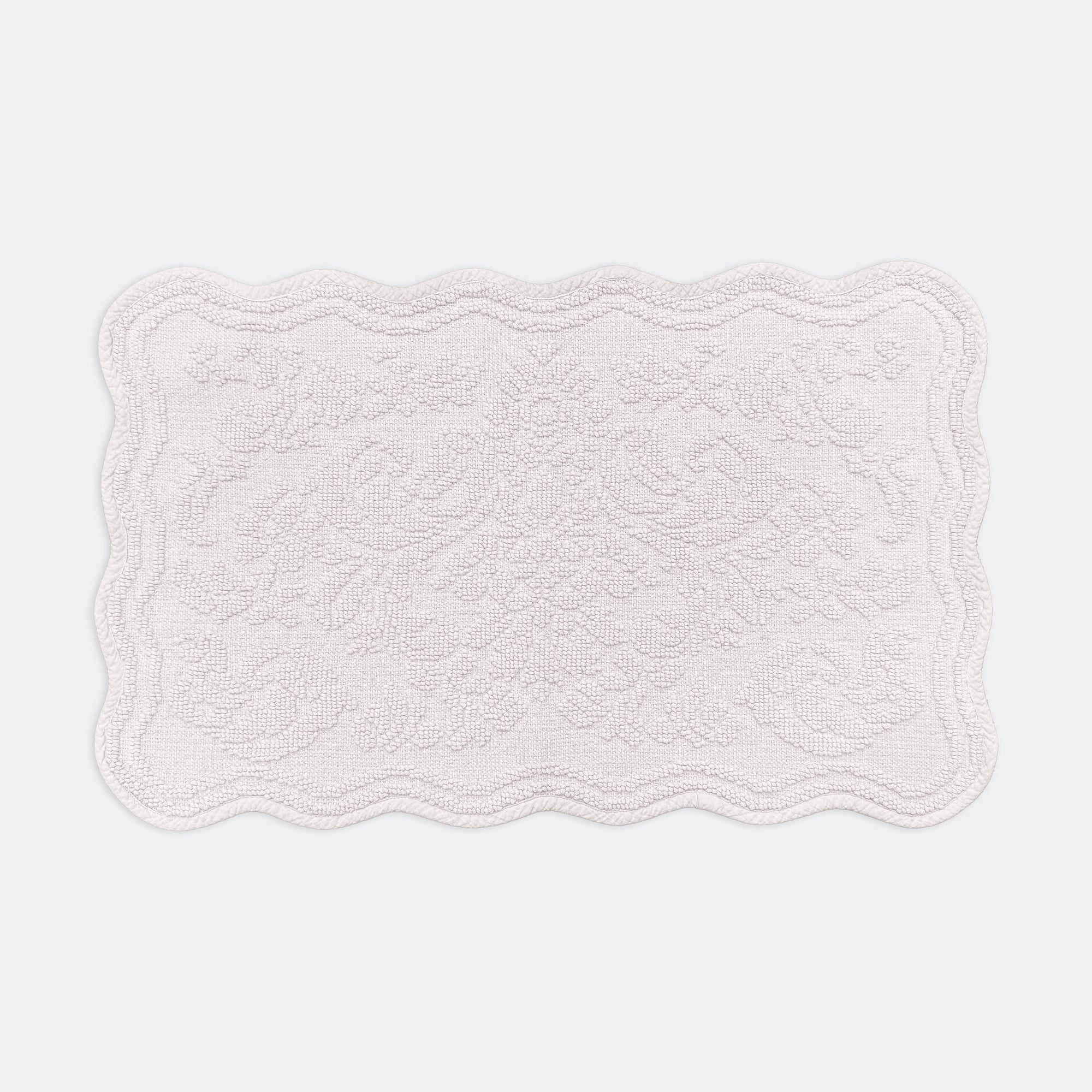 Scalloped bath mat in light grey colour, with floral texture design - made from 100% cotton.