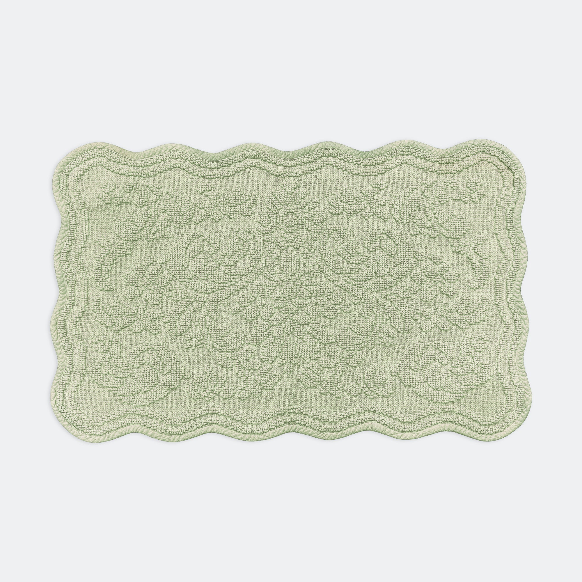 Scalloped bath mat in sage green colour, with floral texture design - made from 100% cotton.