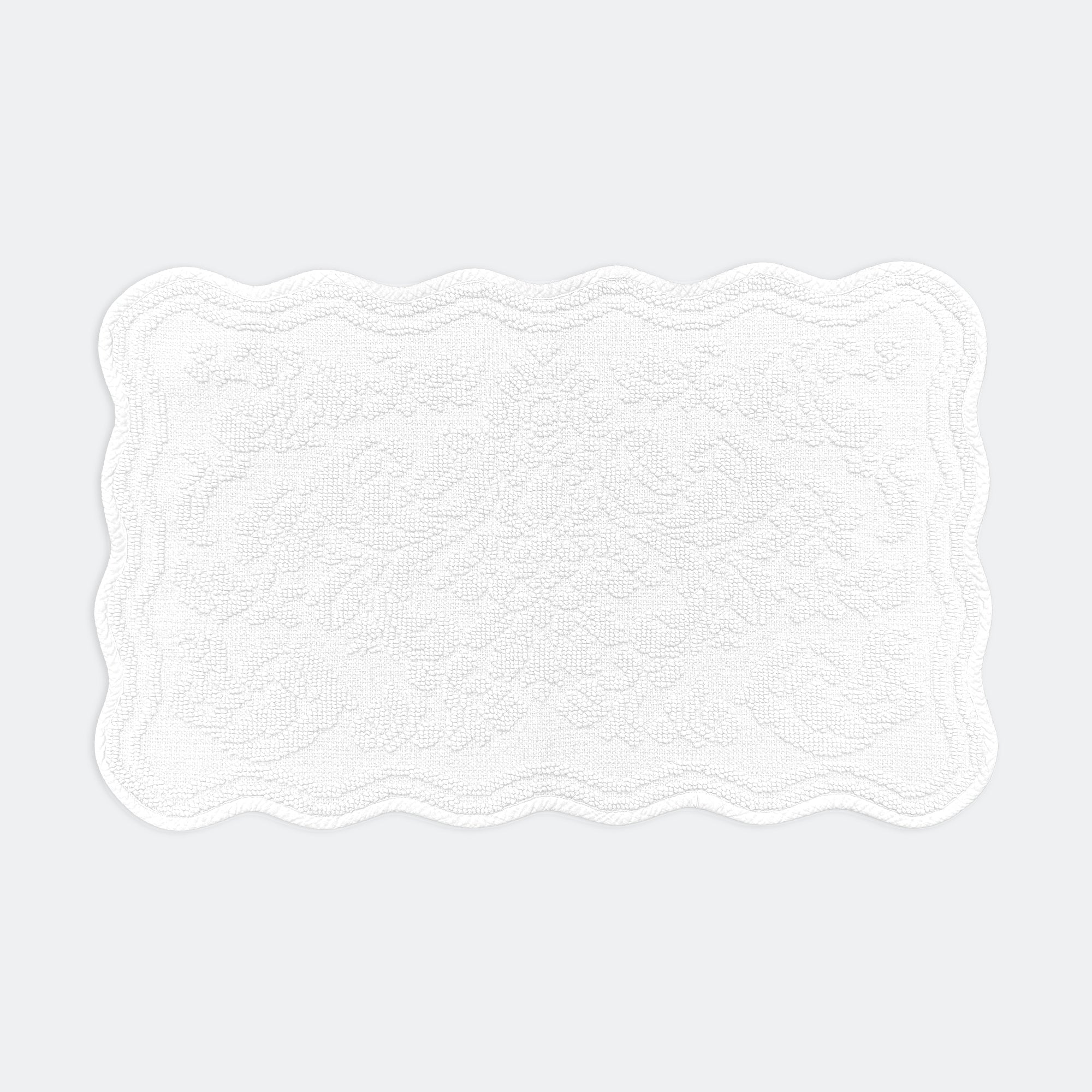 Scalloped bath mat in white colour, with floral texture design - made from 100% cotton.