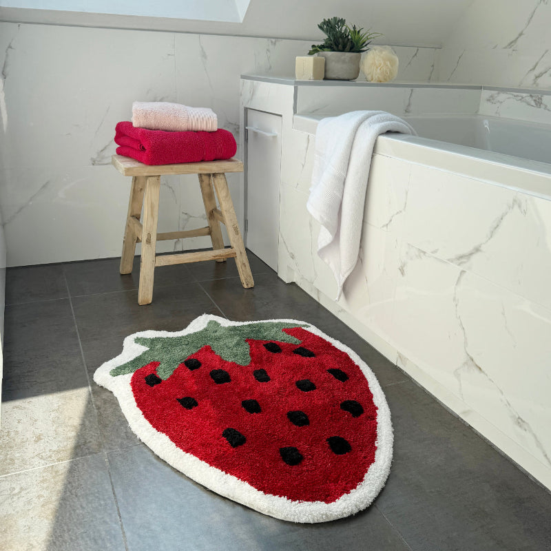 Fun shaped red strawberry rug, super soft. Cute novelty rug for the bedroom.