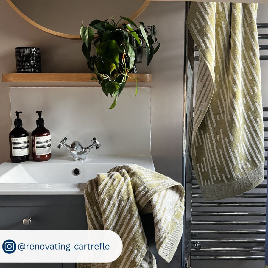 White and green towels in stripe design. Plush bath towels and hand towels for the bathroom.