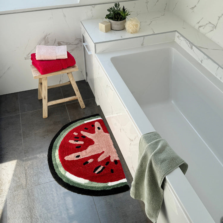 Fun hand tufted fruit bath mat in semi circle shape.