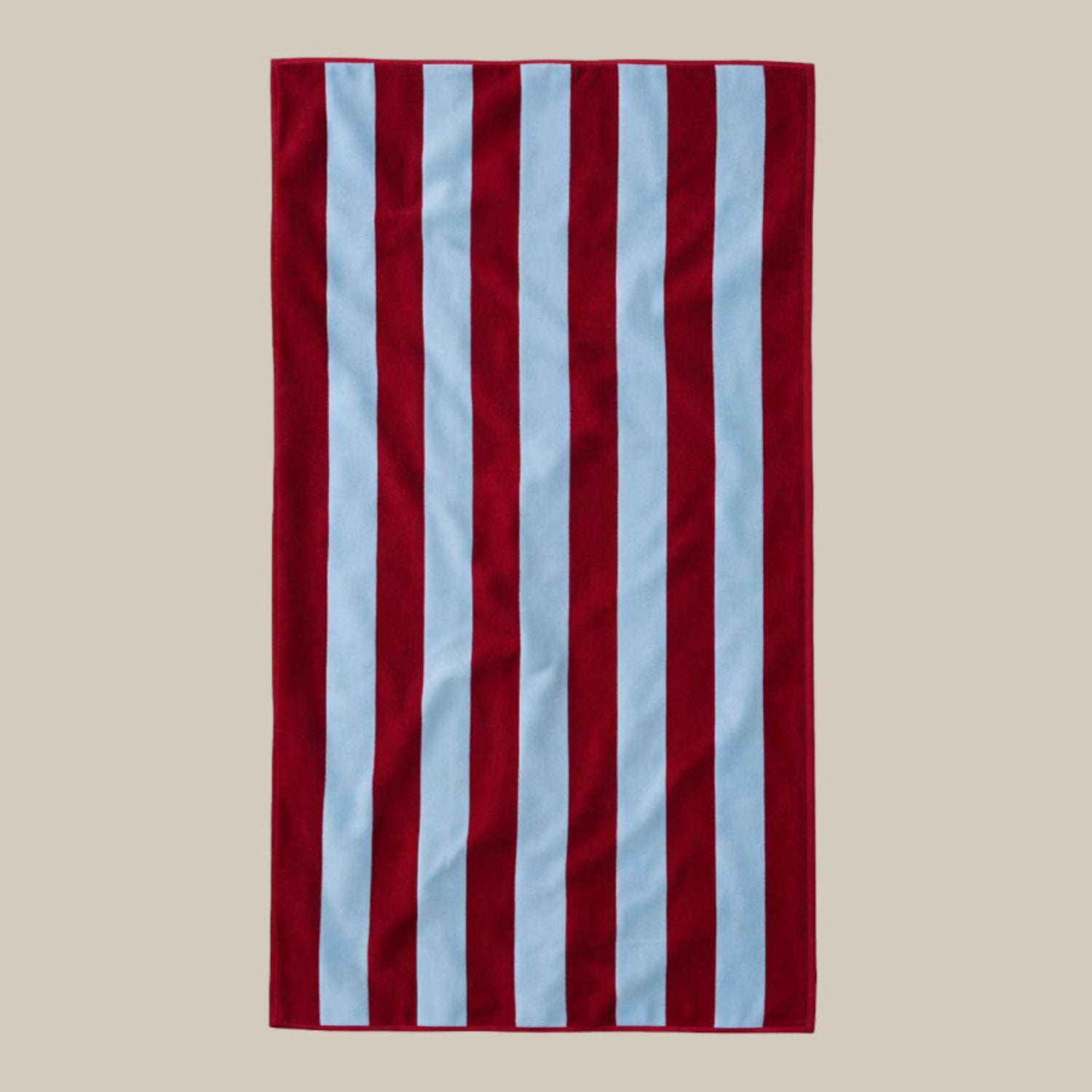 Red and light blue striped towel on a beige background