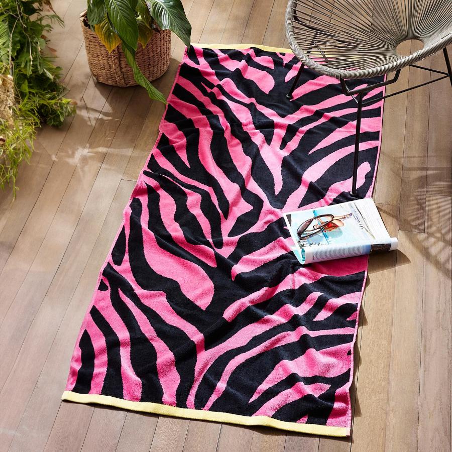 Y2K style pink zebra patterned beach towel.