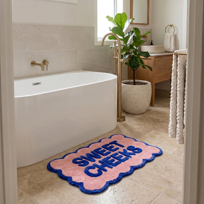 Fun scalloped bath mat in bright blue and pink colours - sweet cheeks slogan.