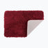 Shaggy burgundy bathroom mats with non slip backing.