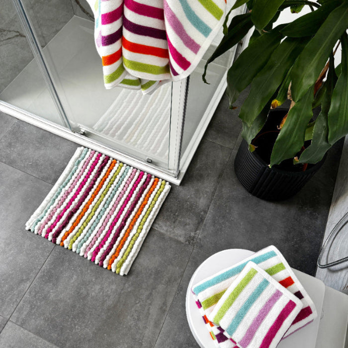 Rainbow stripe patterned towels in blue, orange, green and pink.