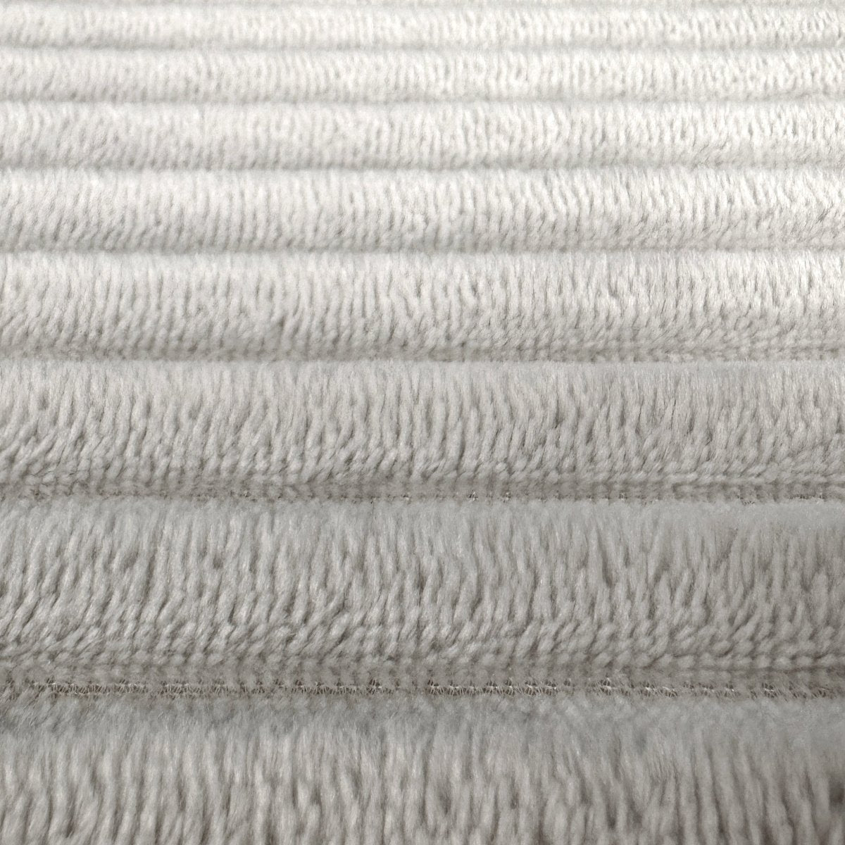 Soft ribbed bath mat made from memory foam, light grey.