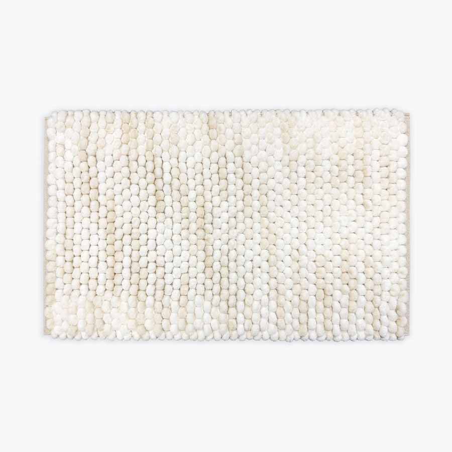White and beige bathroom mat with deep pile bobbles.