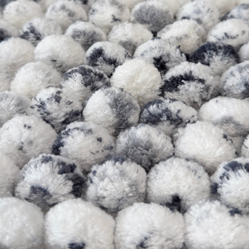 Close up of white and grey marble bath mats.