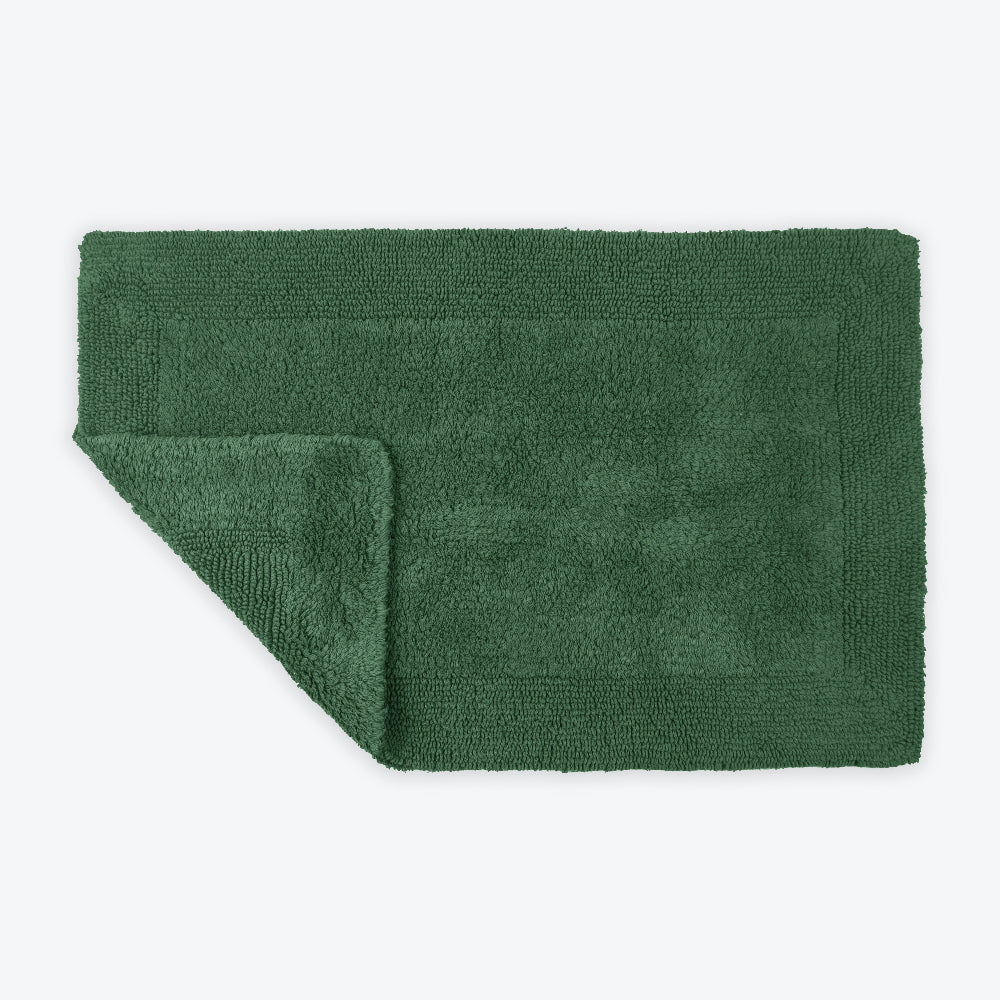Dark green reversible cotton bath mat.