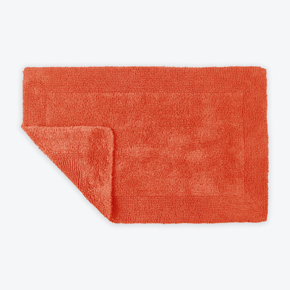 Terracotta bath mat with reversible design.