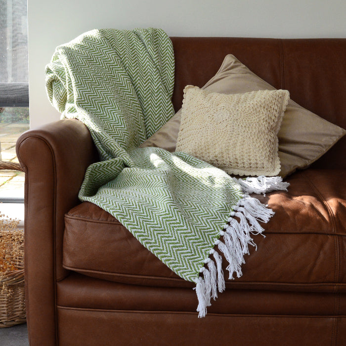 Green and white chevron blanket with tasselled fringe made from 100% cotton.