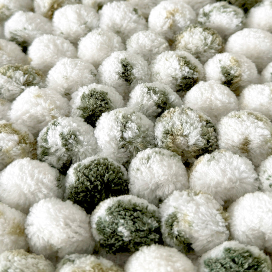 White and green bath mat close up - marble pattern