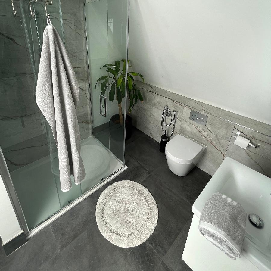 Grey bath towels and colour matching round bath mat.