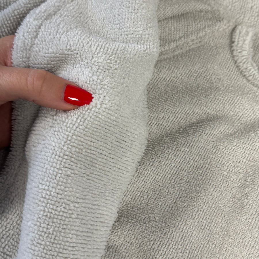 Light grey dressing gown with reversible textures for comfort and practicality.