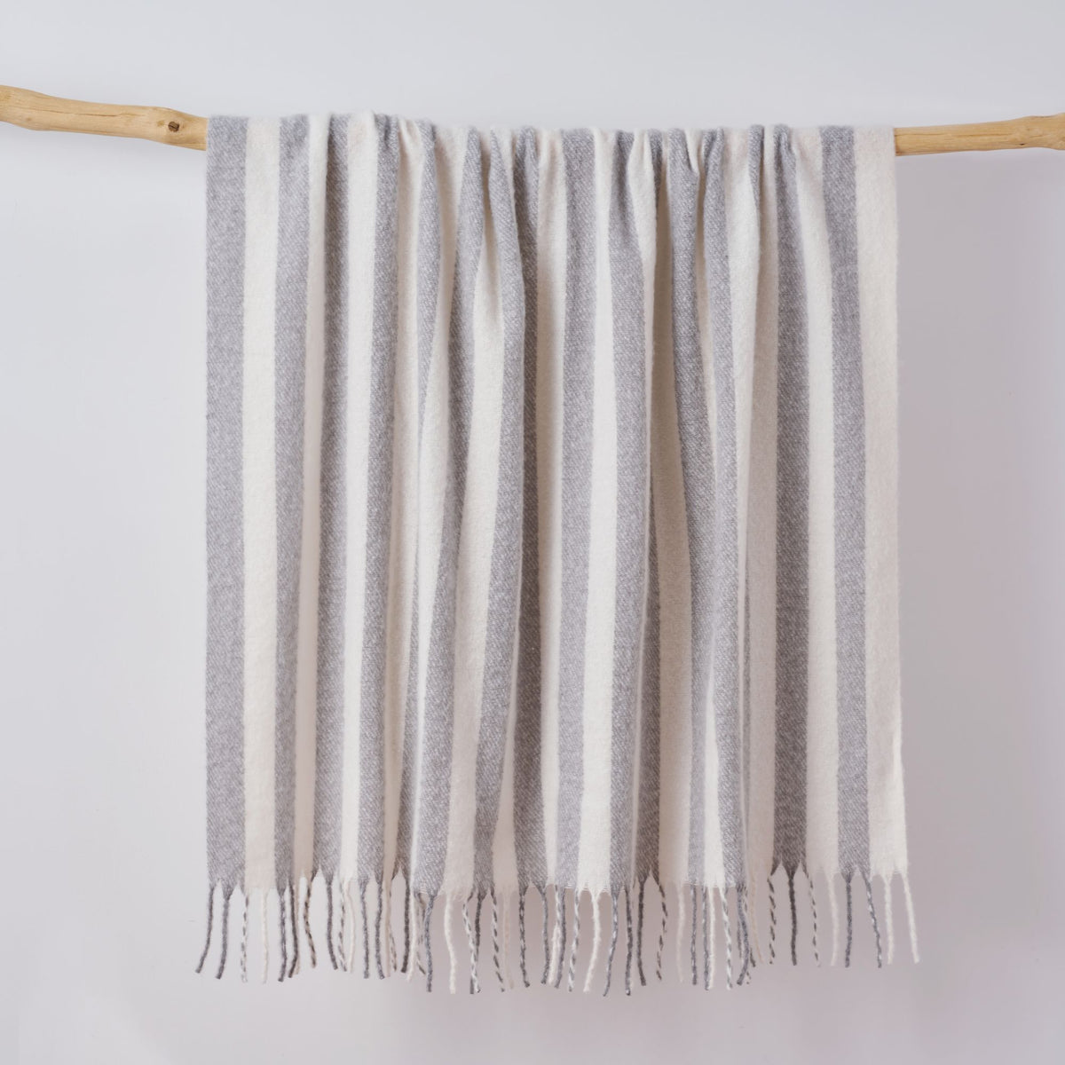 Grey and white striped throw blanket with tassels. Super soft faux mohair material.
