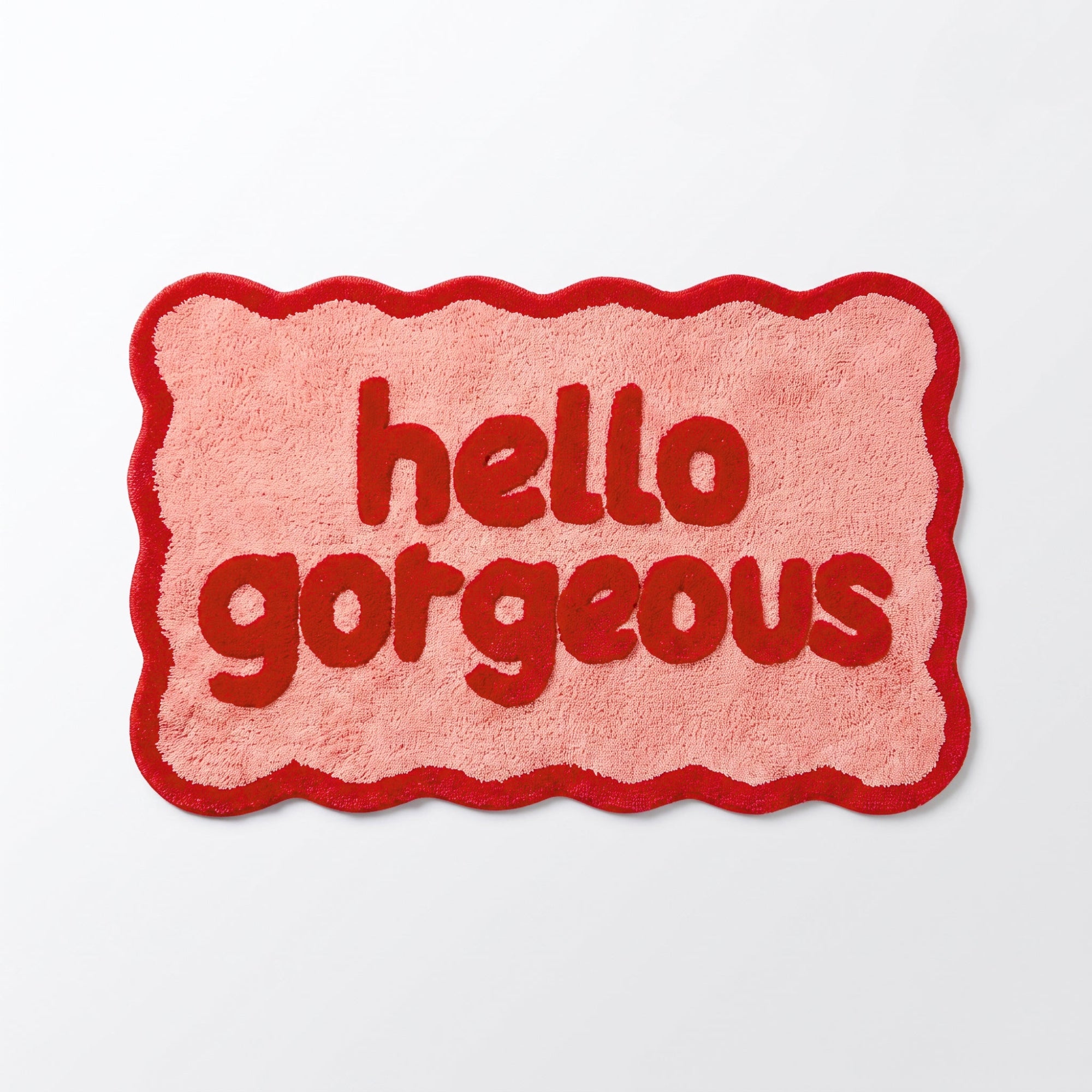 Pink and red bathroom mat with hello gorgeous slogan.