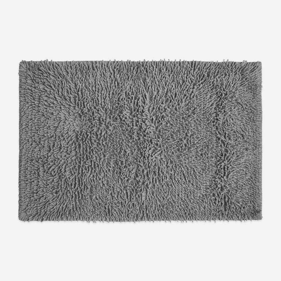 Light grey cotton bath mat, tumble twist design.