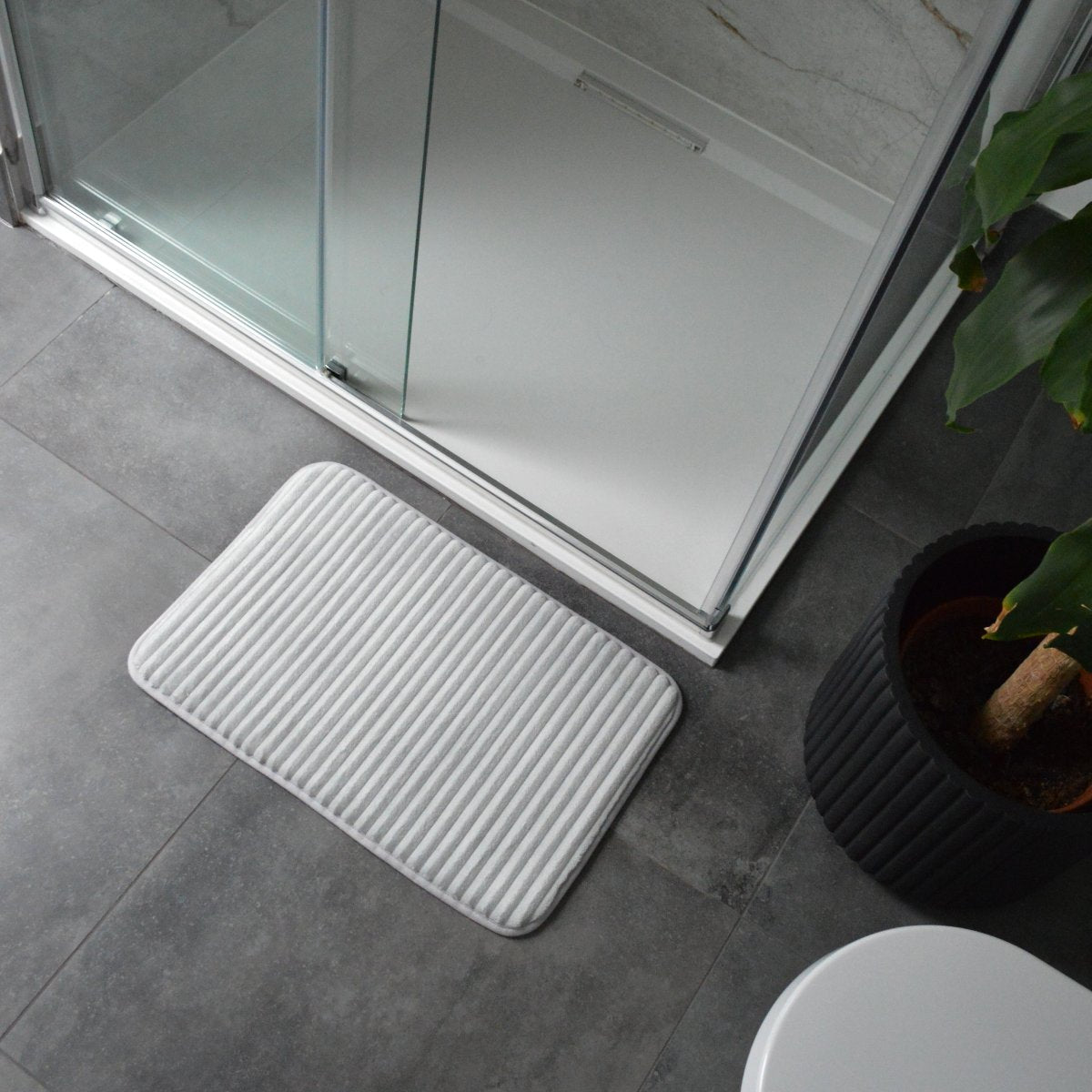 Grey bathroom memory foam bath mats with non slip backing.