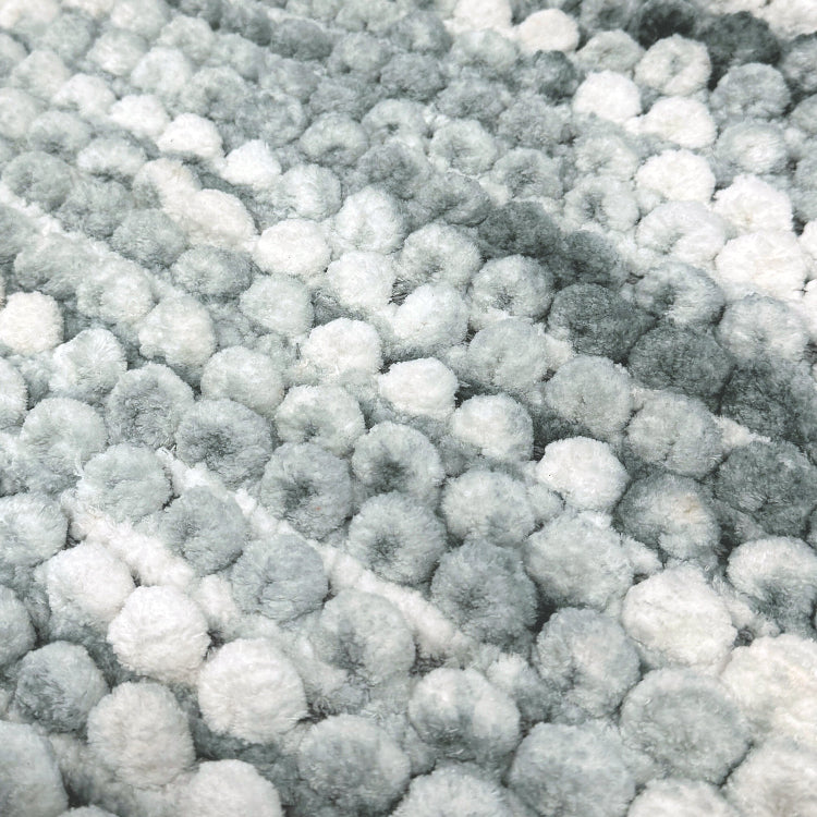 Grey and white patterned bath mat.
