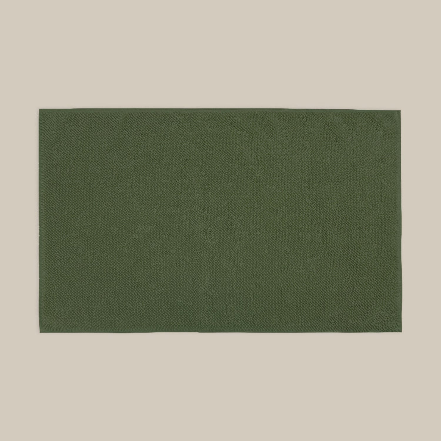 Dark green bath mat made from organic cotton. Soft and sustainable bathroom accessories.