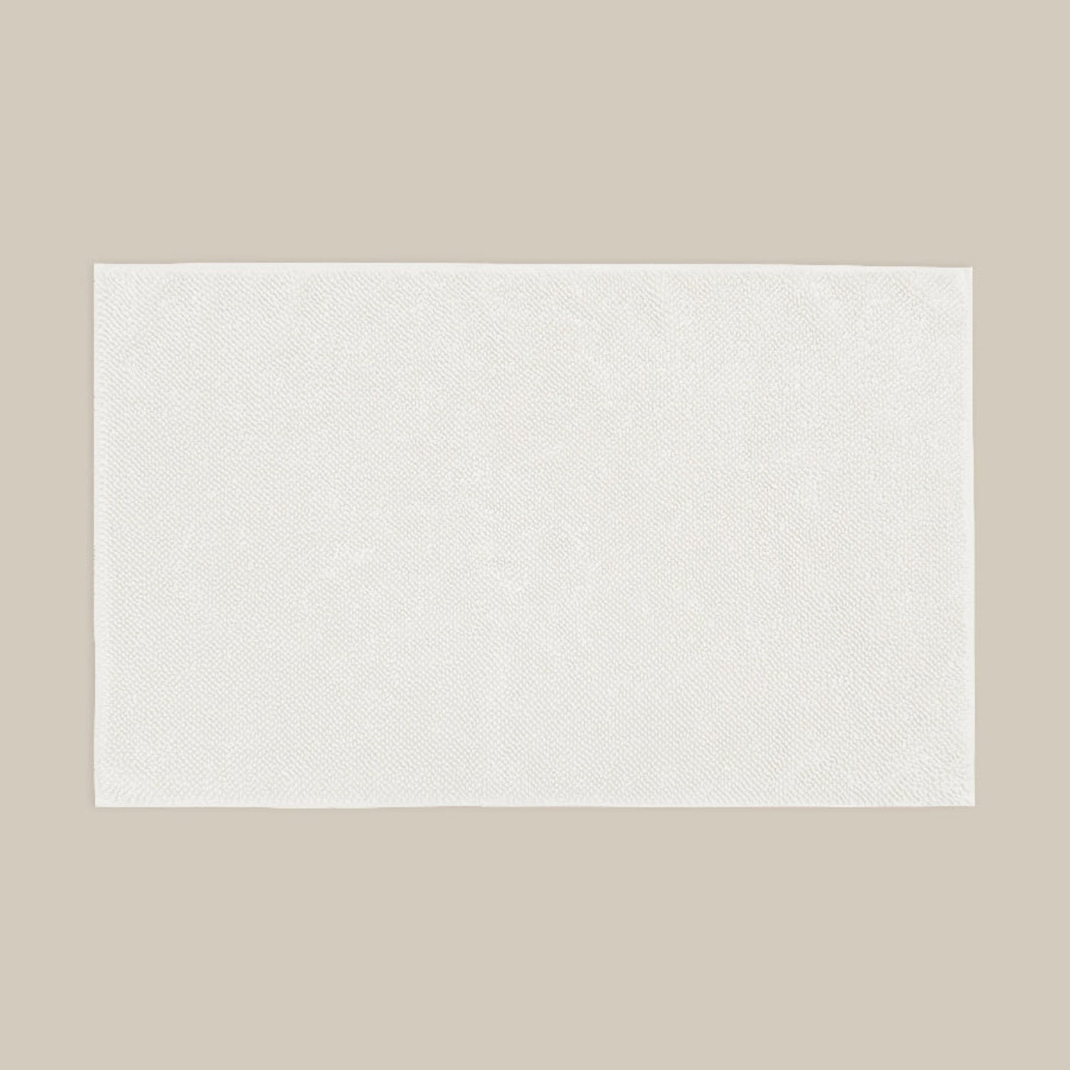 White bath mat made from organic cotton. Soft and sustainable bathroom accessories.