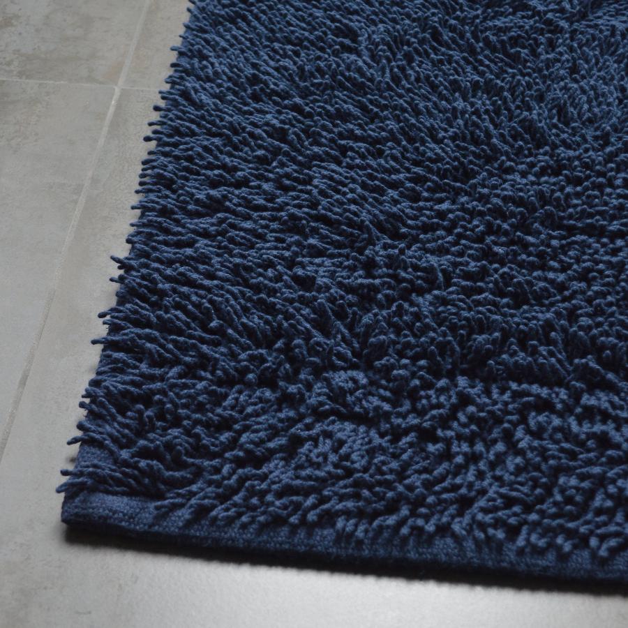 Navy blue shaggy cotton bath mat.
