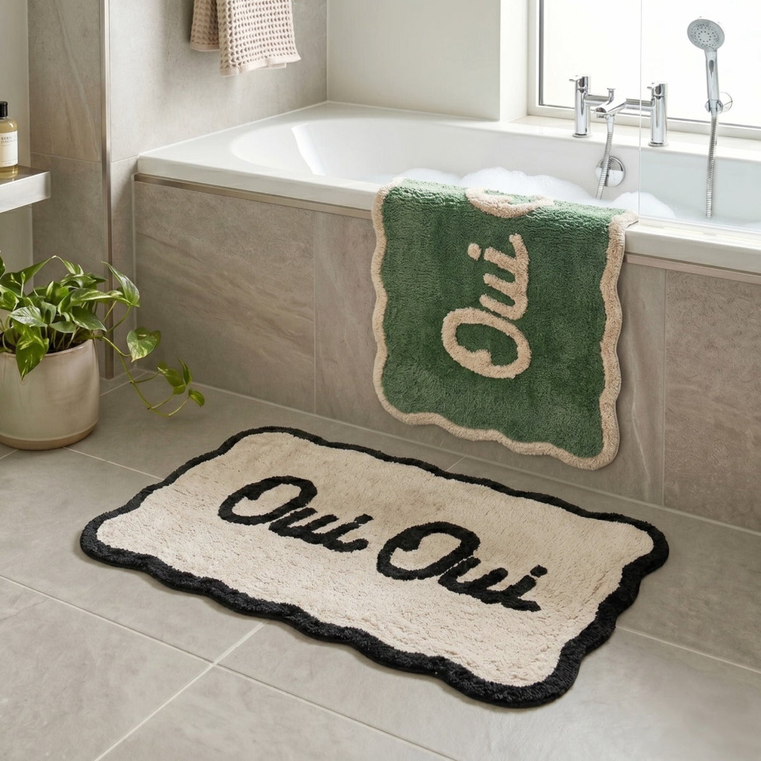 Bathroom with Oui Oui bath mat on a tiled floor.